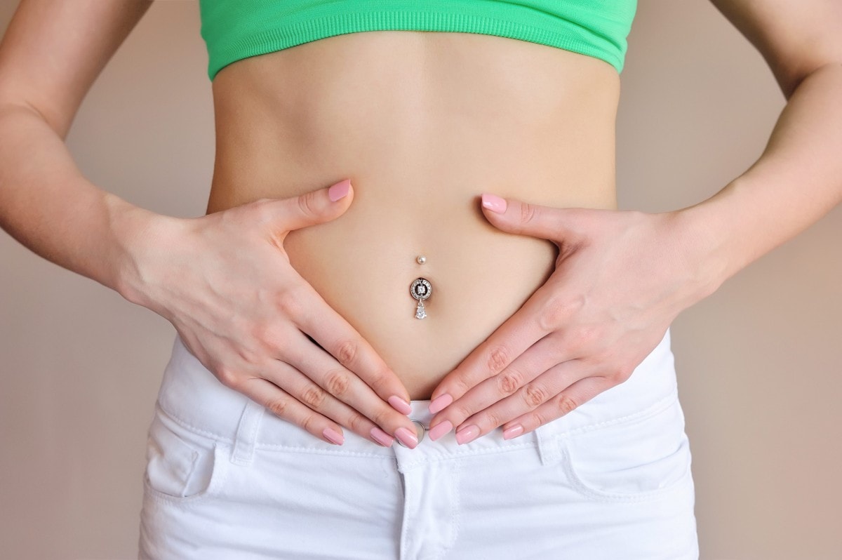 woman-holding-hands-on-a-belly-stomach-health-P84SMZN