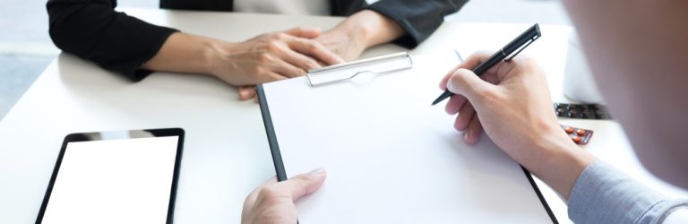 health-care-and-medical-concept-female-doctor-hand-hold-pen-filling-patient-history-list-at-clipboard_t20_9l716A